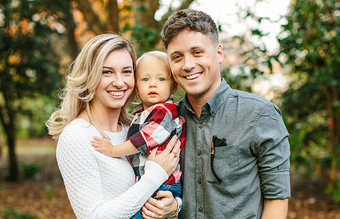 family smiling outside